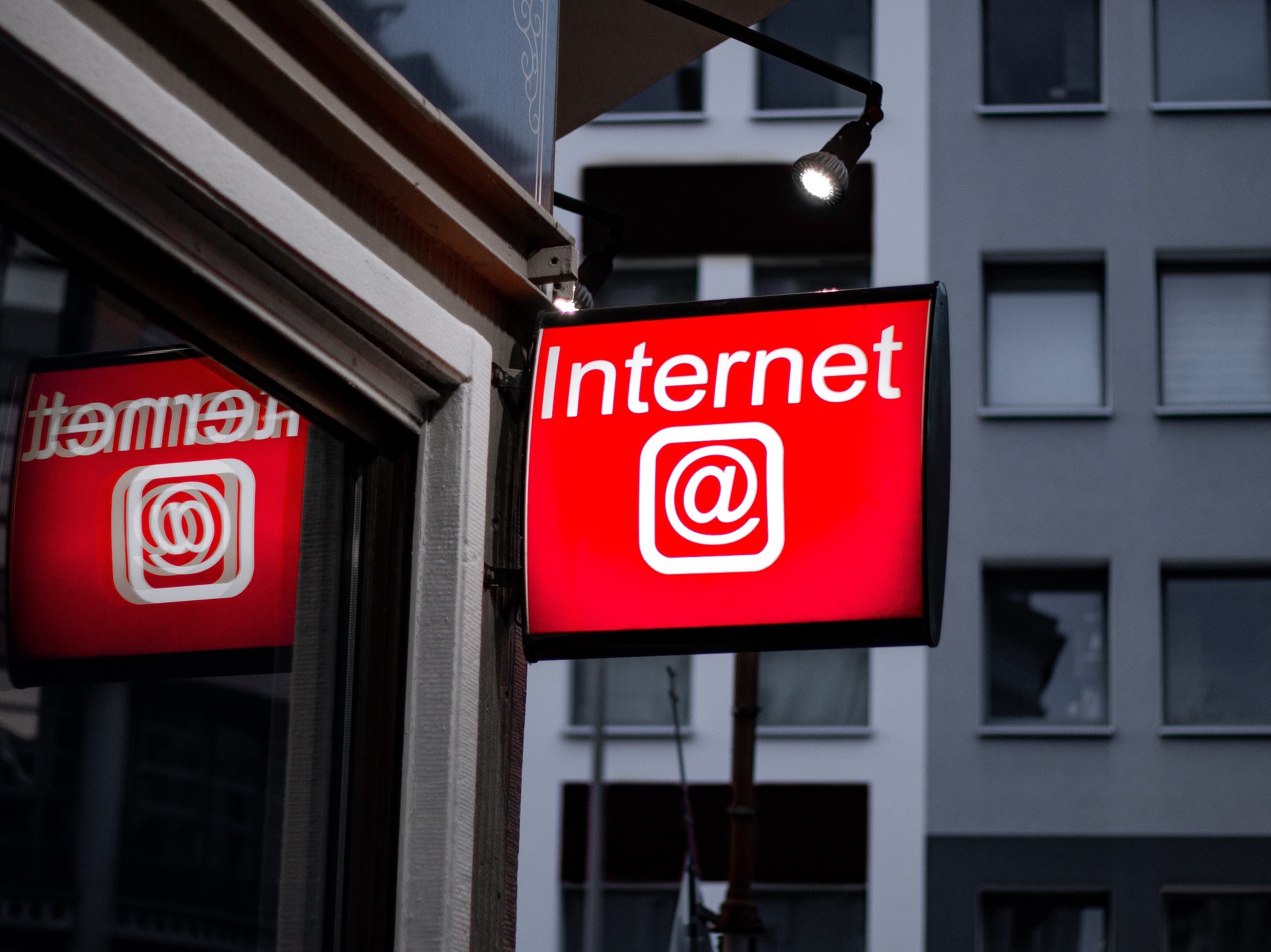Red Internet LED Signage beside building near buildings Photo by Leon Seibert on Unsplash