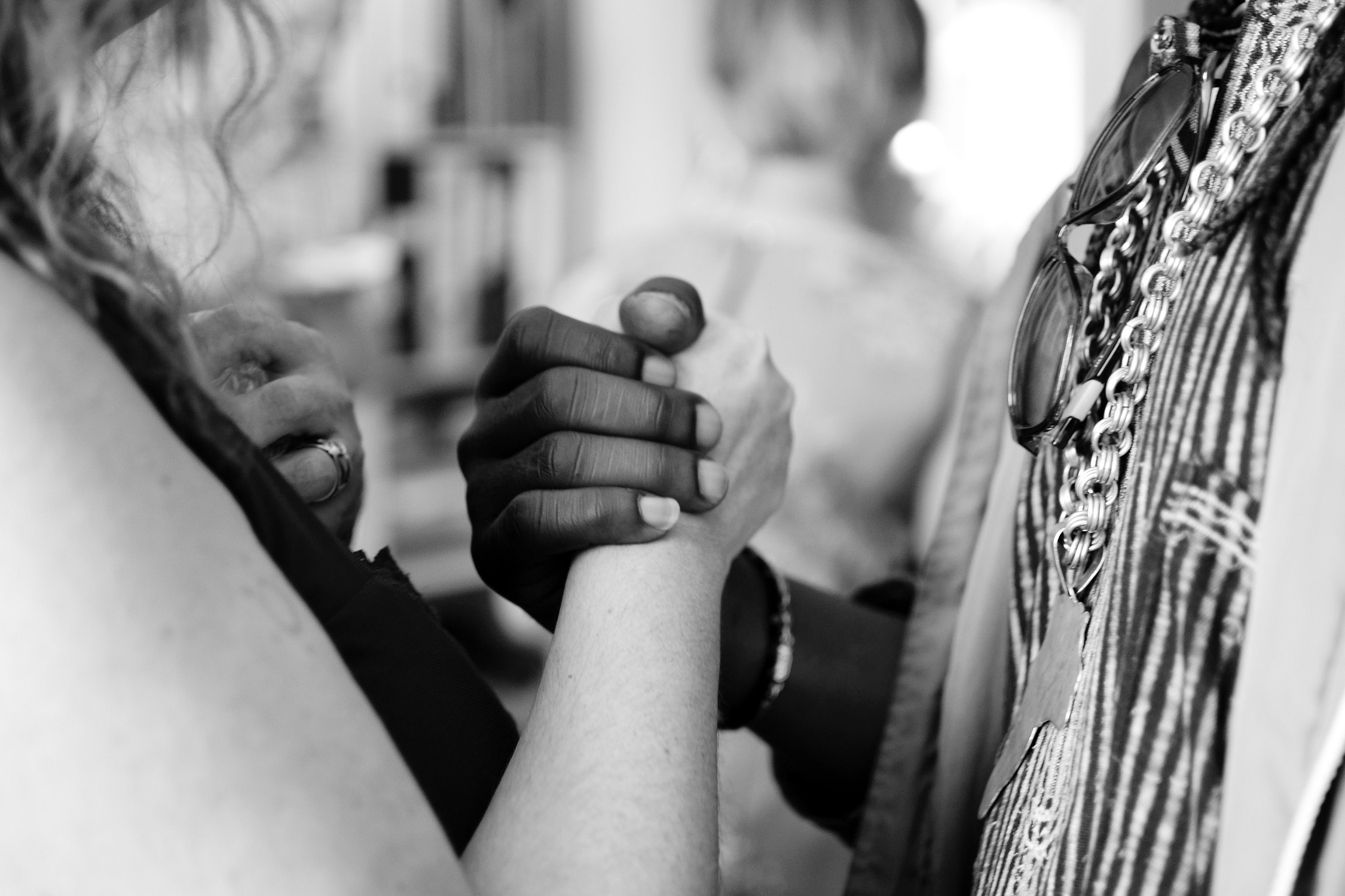 Grayscale photo of a man and a woman holding hands Photo by Aarón Blanco Tejedor on Unsplash